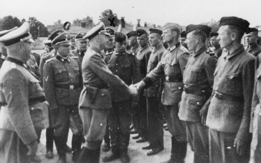 Tato fotografie z roku 1942, kterou poskytla státní prokuratura v Hamburku prostřednictvím United States Holocaust Memorial Museum, ukazuje Heinricha Himmlera uprostřed vlevo, jak si potřásá rukama s novými rekruty do gardy v koncentračním táboře Trawniki v nacisty okupovaném Polsku. (úřad státního zastupitelství v Hamburku přes United States Holocaust Memorial Museum přes AP)